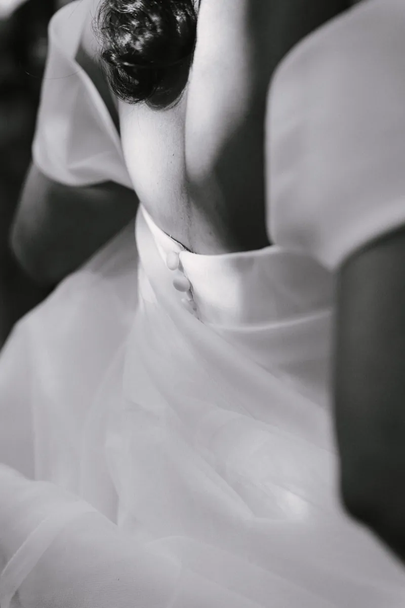 Close on the buttons at the back of the dress as the couple embrace, Biniagual, Mallorca