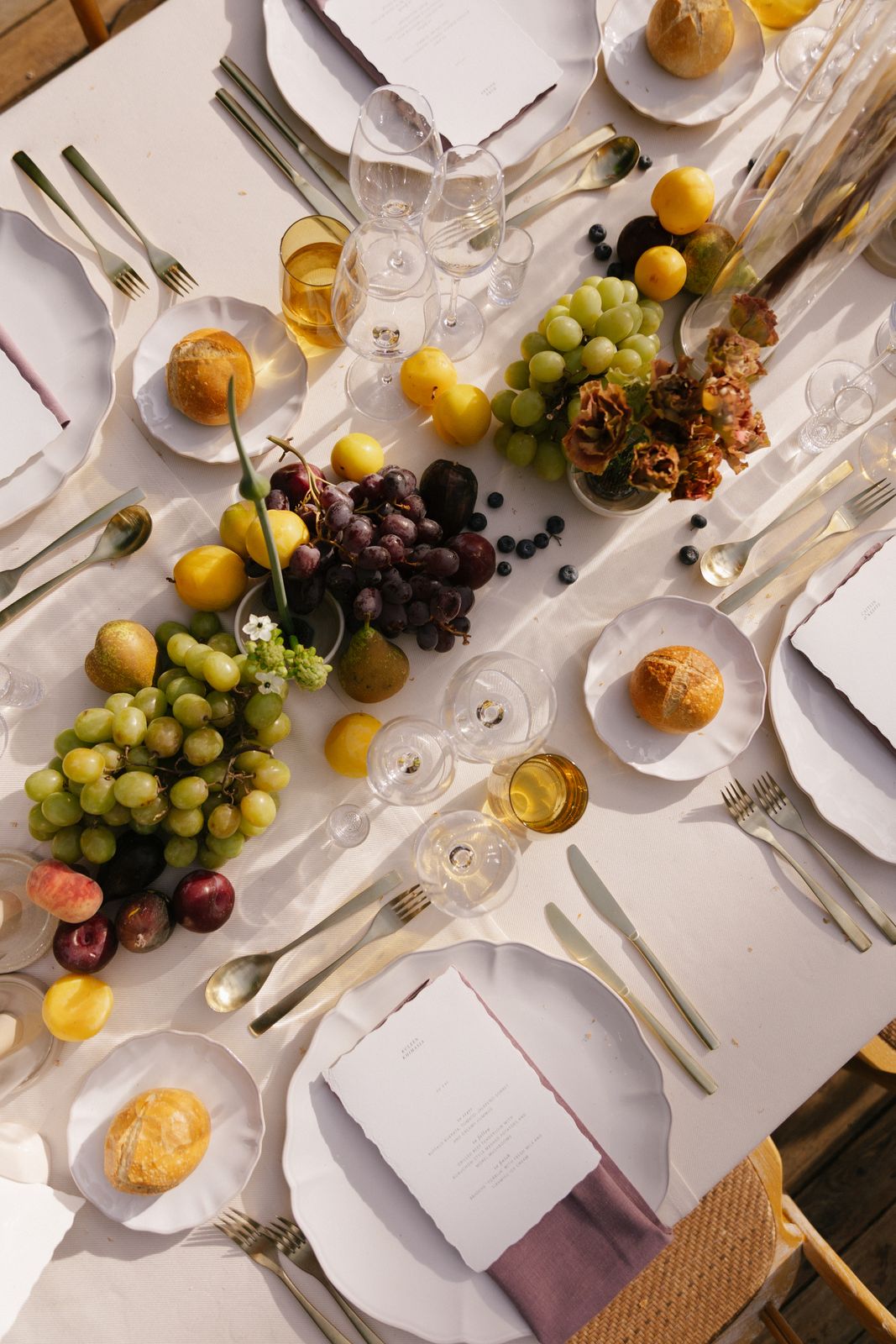 Long tables dressed with figs and peaches at Jardines de Alfabia, Mallorca