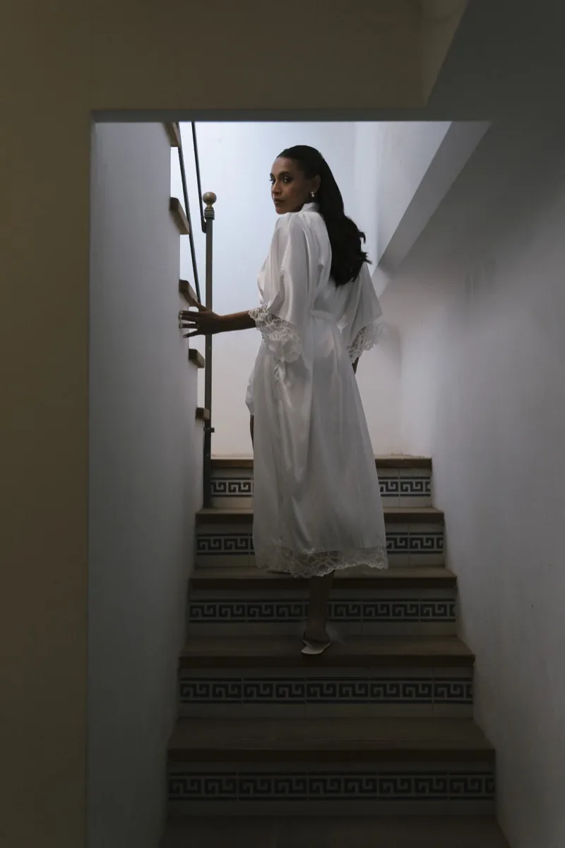 The bride coming down the tiled staircase in her robe, Es Mitja Fondo, Mallorca