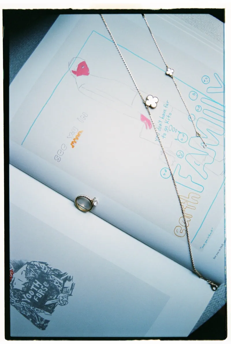 The bride’s necklace and ring laid on the stationery, L’Avenida Hotel, Sóller, Mallorca
