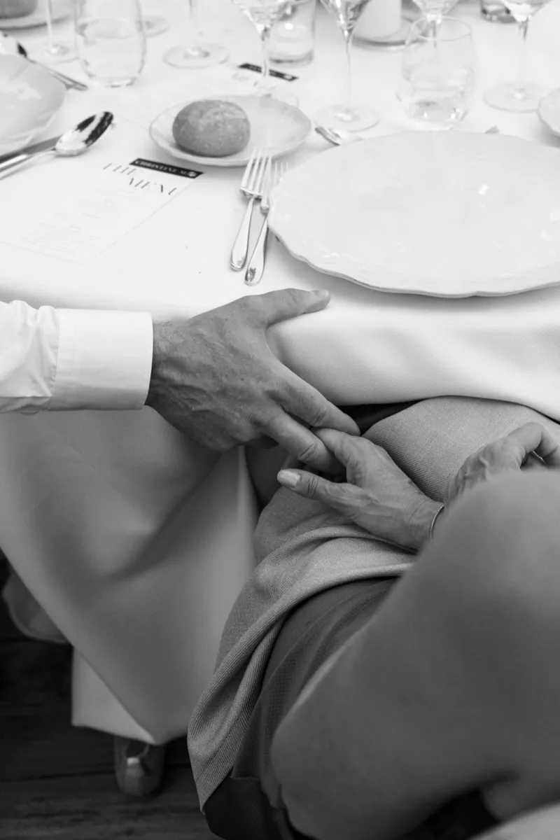 A hand resting on a lap at the table during dinner, Jardines de Alfabia, Mallorca