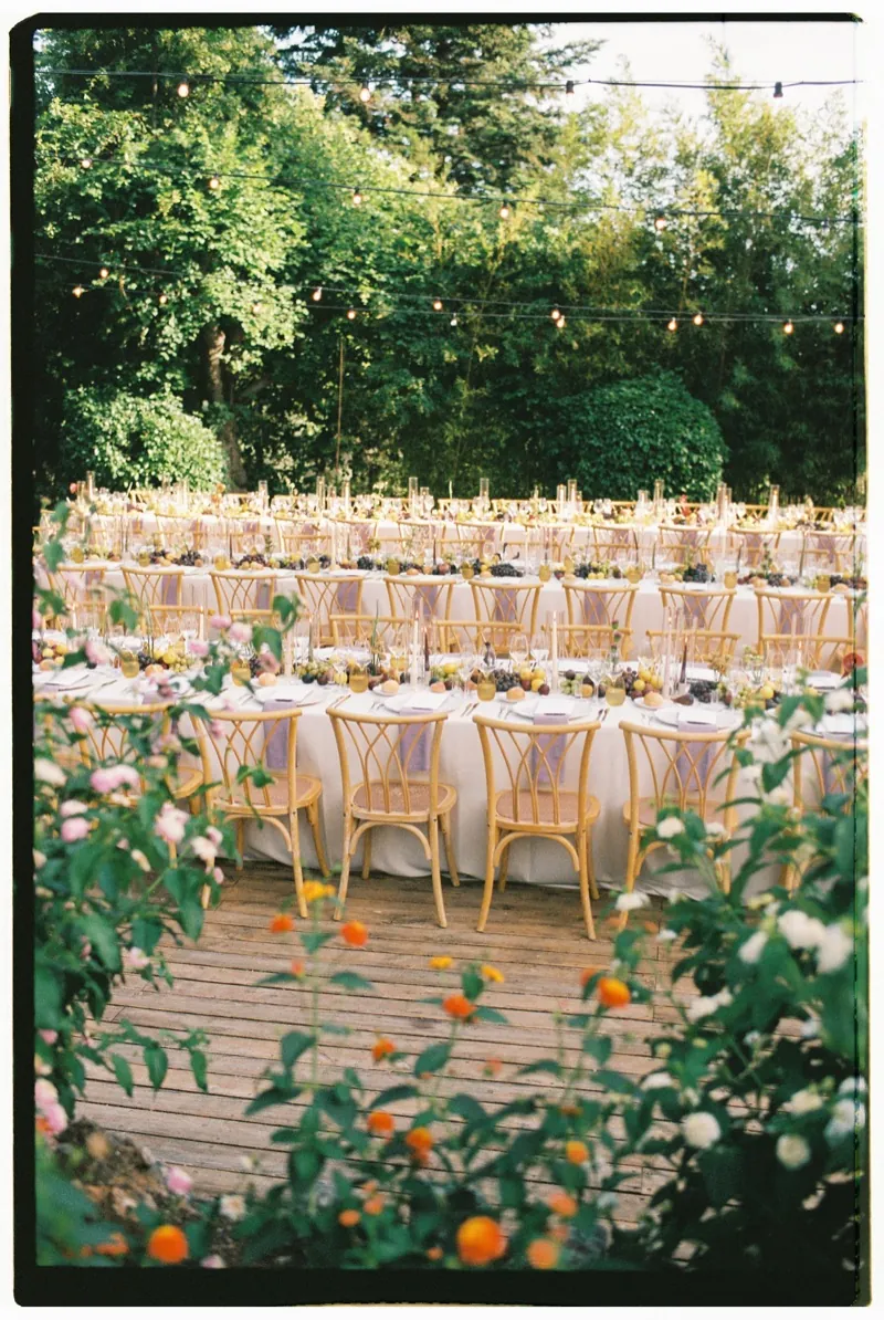 Long tables set among the orange trees and the greenery, shot on 35mm film, Jardines de Alfabia, Mallorca
