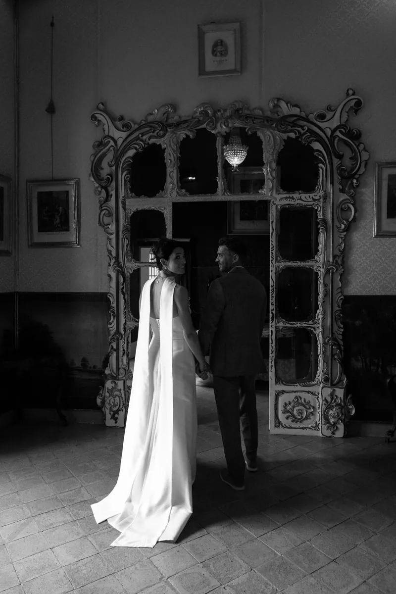 The dress hanging before an ornate carved mirror, Jardines de Alfabia, Mallorca