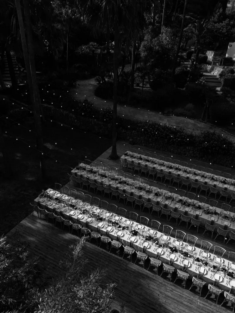 Rows of empty ceremony chairs seen from above at dusk, Jardines de Alfabia, Mallorca