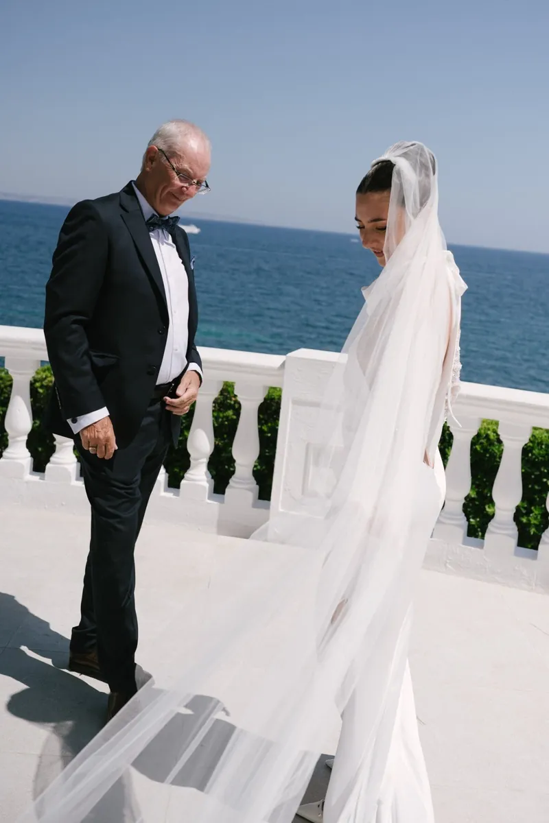 The bride and her father on the terrace above the sea, the veil trailing, Lume & Co, Génova, Mallorca