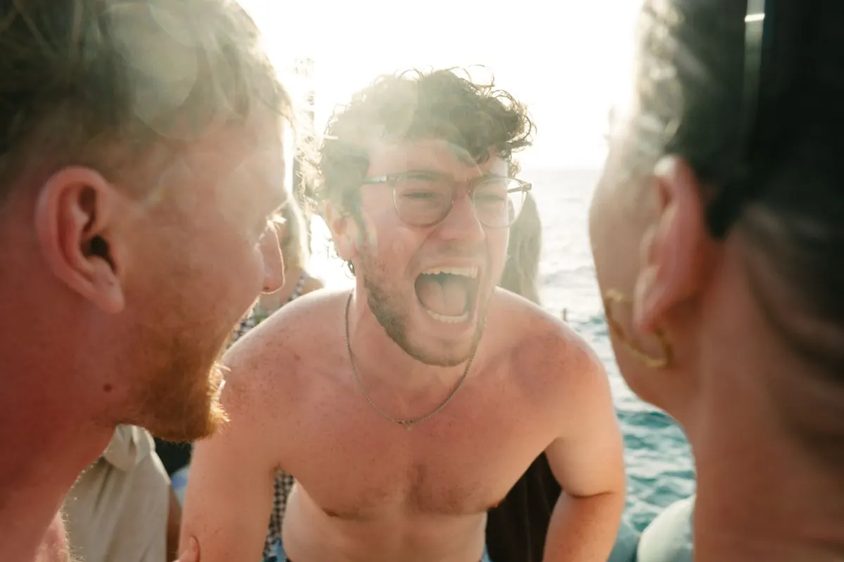 Cake, confetti and dancing on the deck of Falcao Uno at sunset, Mallorca