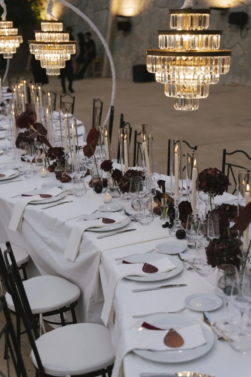 The dinner tables under crystal chandeliers, dark flowers and candlelight, Son Marroig, Deià, Mallorca