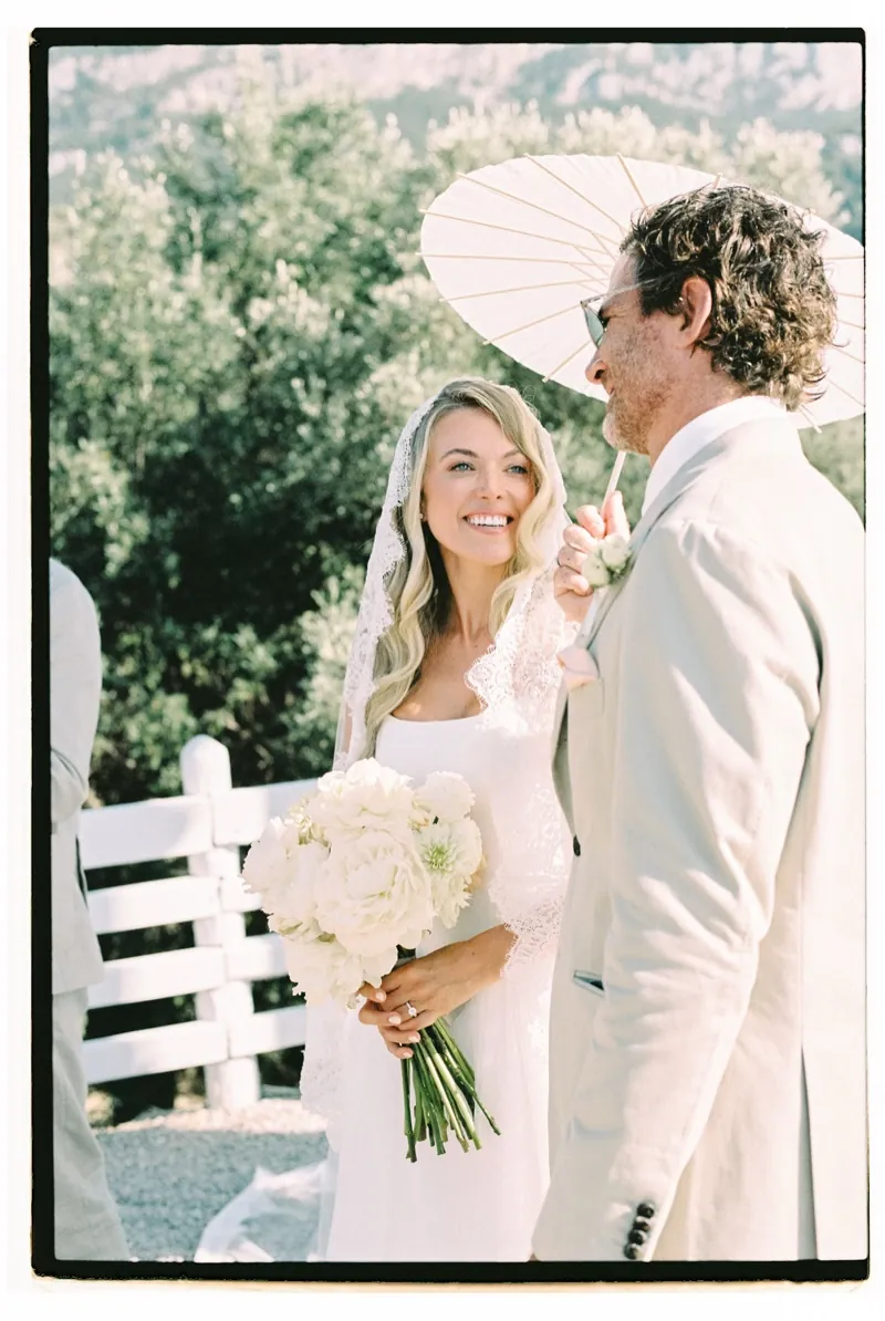 The couple under a white parasol after the ceremony, shot on 35mm film, Son Marroig, Deià, Mallorca