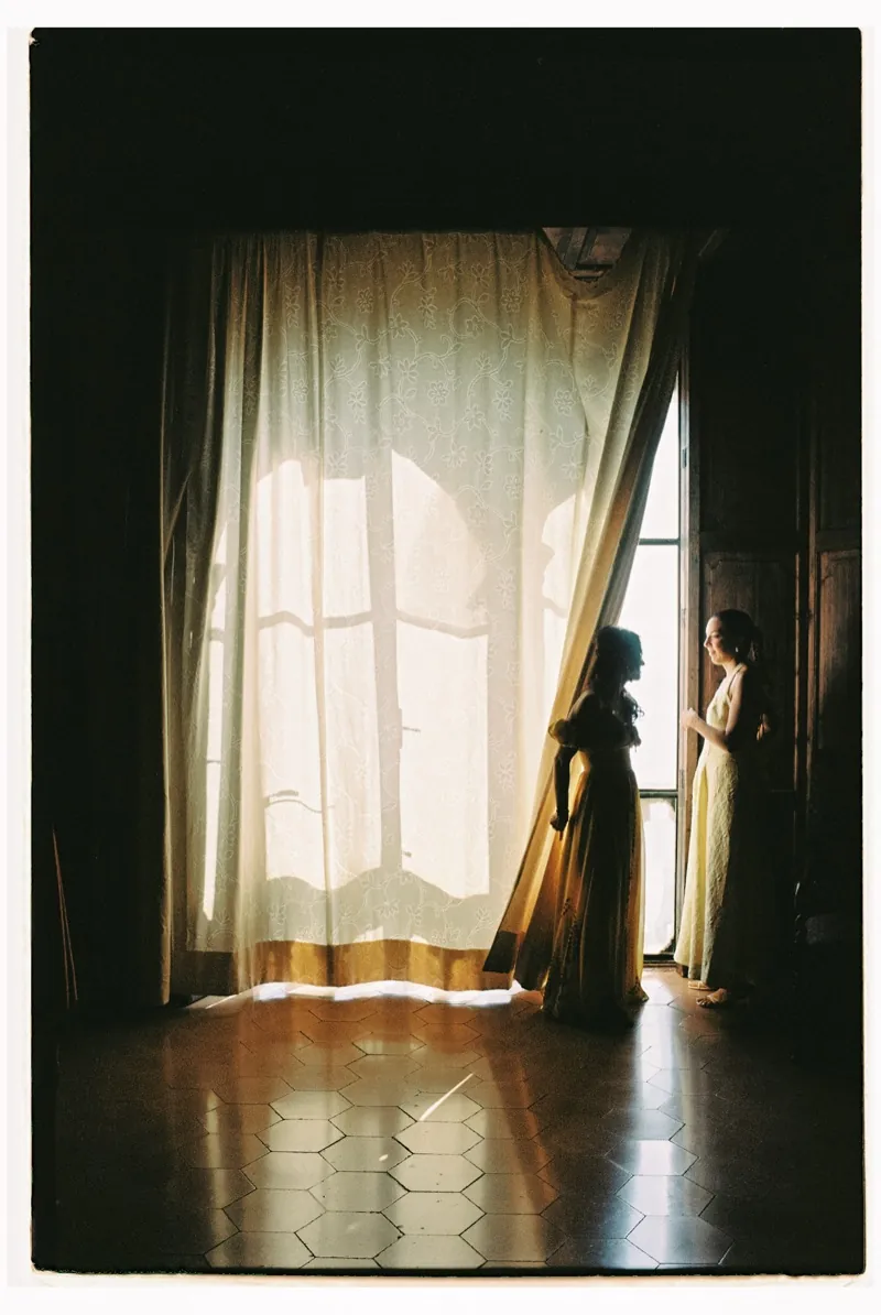 A figure at the curtained window in the dark interior, shot on 35mm film, Son Marroig, Deià, Mallorca